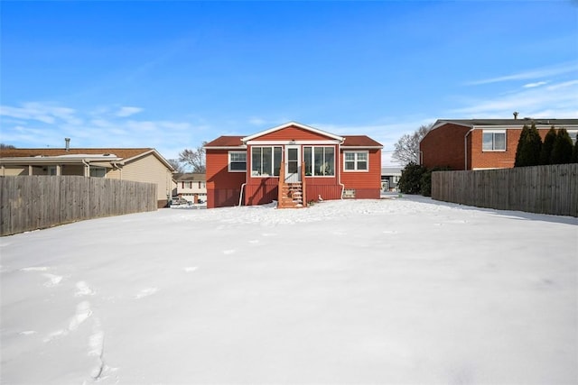 view of snow covered back of property