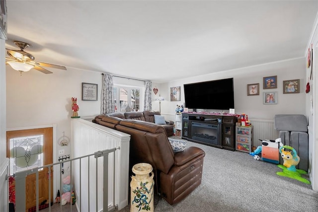 living room with carpet floors, ceiling fan, and a fireplace