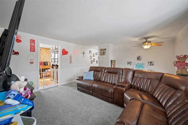 carpeted living room with ceiling fan