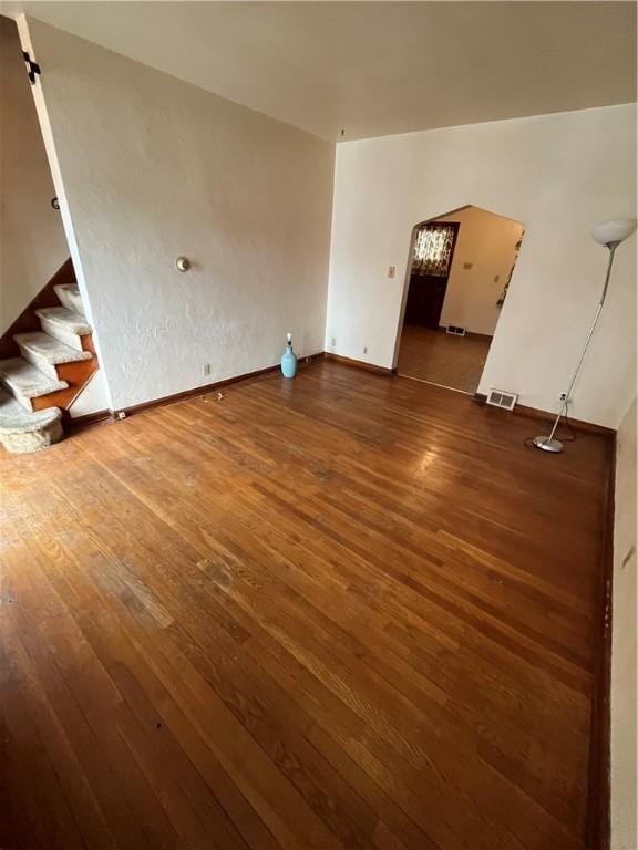 unfurnished living room with dark hardwood / wood-style flooring