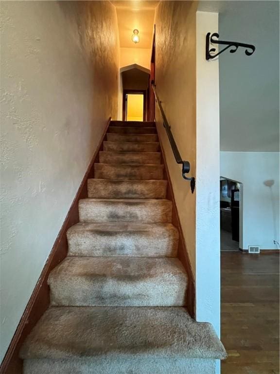 staircase with hardwood / wood-style flooring