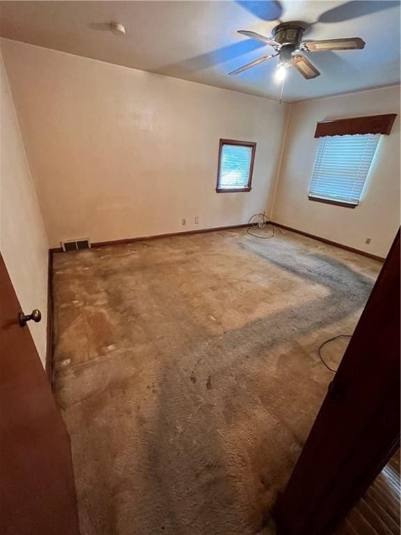 spare room featuring ceiling fan and carpet flooring