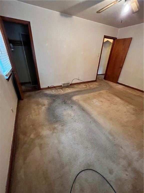 interior space with ceiling fan and concrete flooring