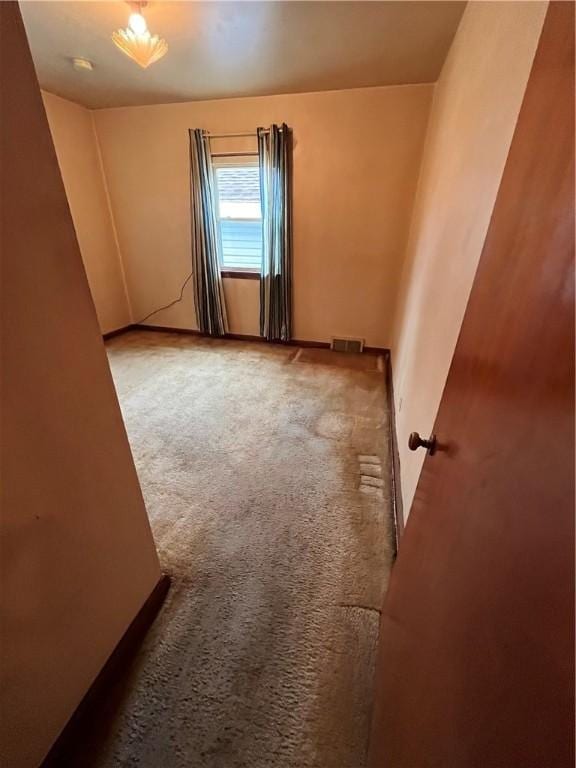 spare room featuring carpet