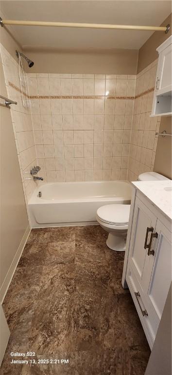 full bathroom with toilet, vanity, and tiled shower / bath