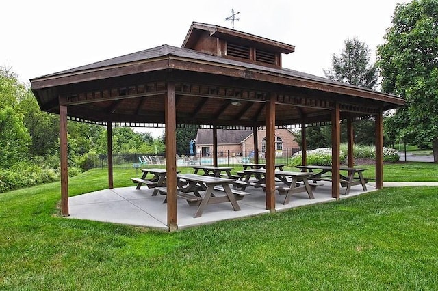 view of property's community with a patio area, a gazebo, and a lawn