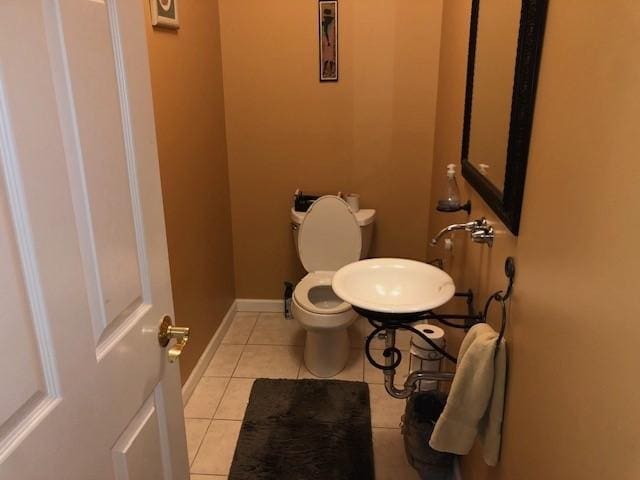 bathroom with sink, tile patterned floors, and toilet