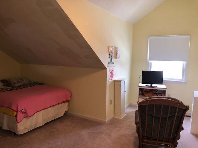 bedroom featuring lofted ceiling and light carpet