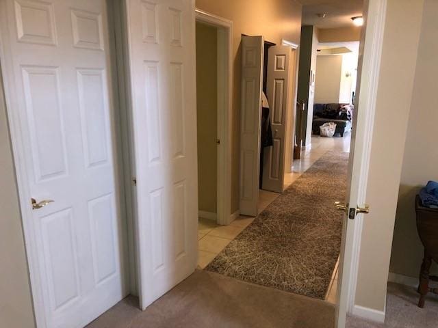 hallway featuring light tile patterned floors