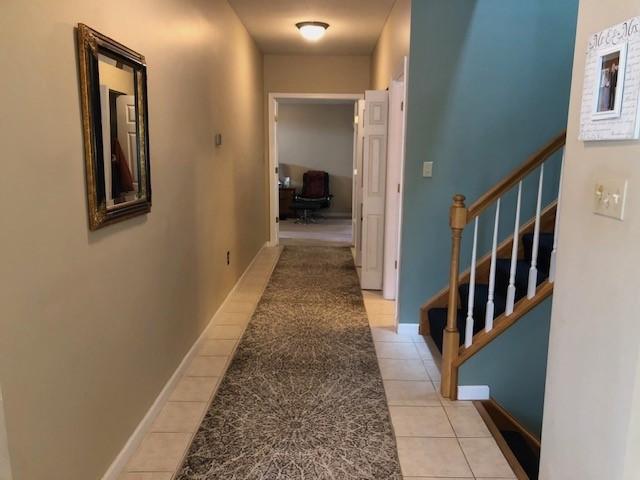 corridor with light tile patterned flooring