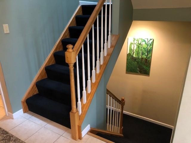 staircase featuring tile patterned floors