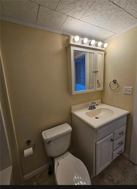 bathroom featuring toilet and vanity