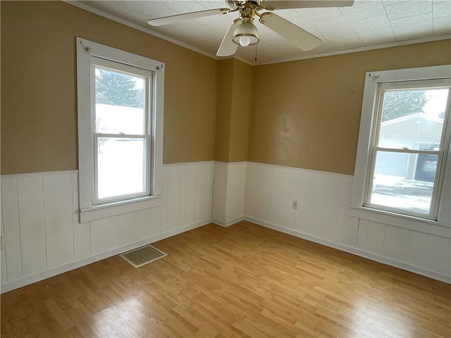 unfurnished room with light wood-type flooring and a healthy amount of sunlight