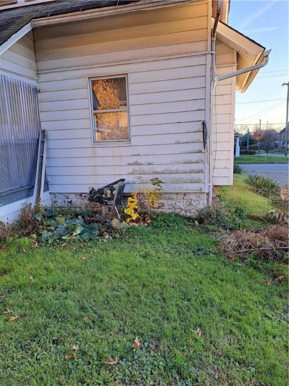 view of side of property with a yard