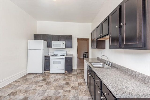 kitchen featuring sink, white appliances, and dark brown cabinets