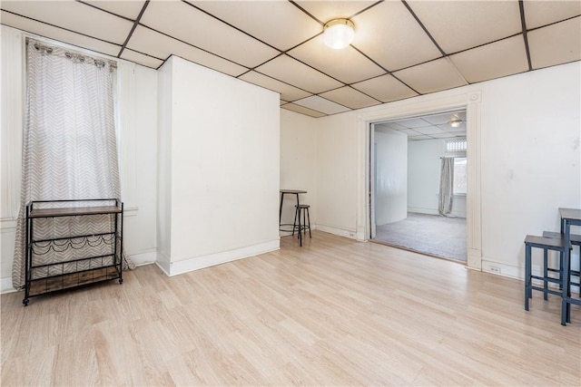 interior space featuring light wood-type flooring and a paneled ceiling