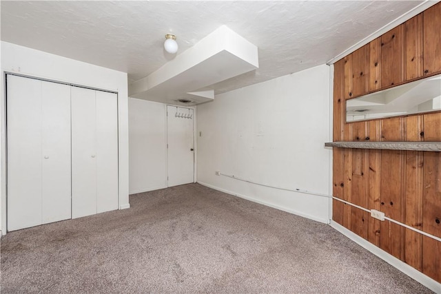 basement with carpet floors and a textured ceiling