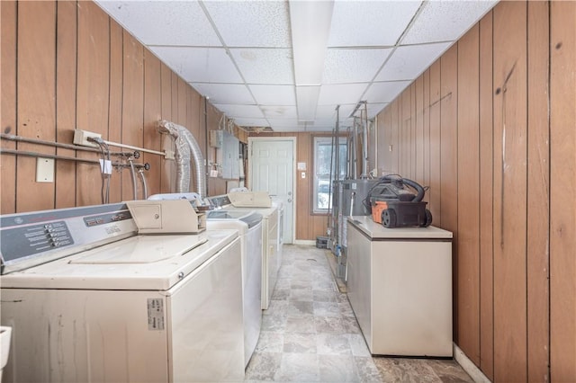 laundry room featuring independent washer and dryer and wooden walls