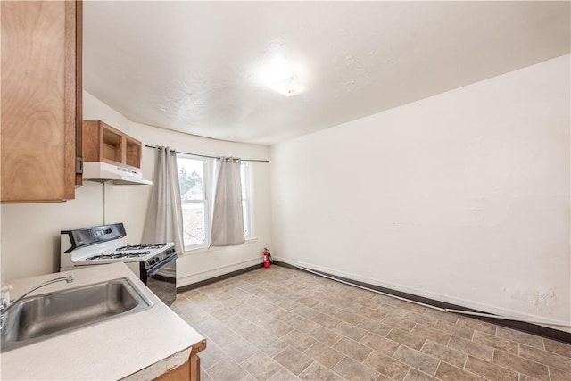 kitchen featuring sink and white range with gas stovetop