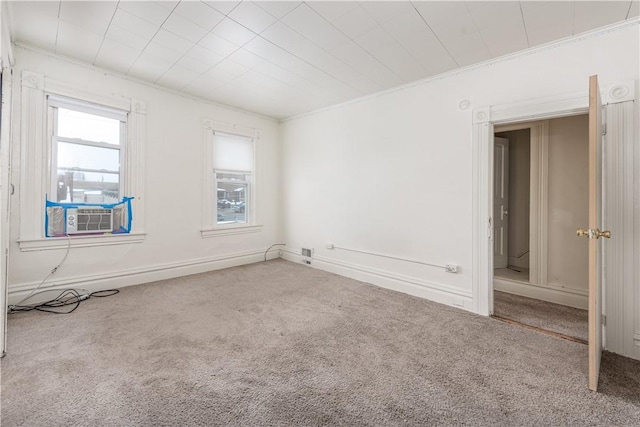 unfurnished room featuring carpet, ornamental molding, and cooling unit