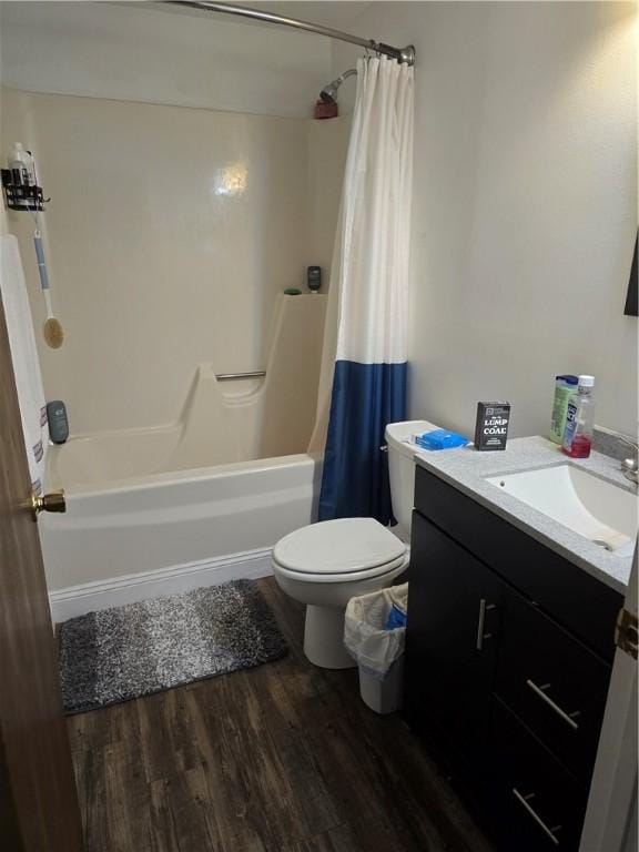 full bathroom with toilet, shower / bath combination with curtain, hardwood / wood-style floors, and vanity