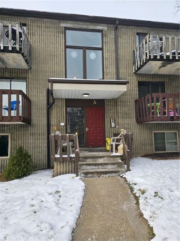 view of snow covered property entrance