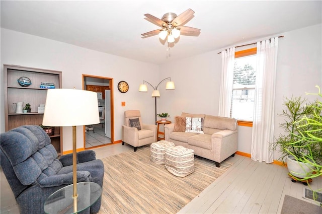 living room featuring ceiling fan and light hardwood / wood-style flooring