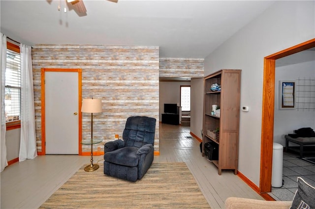 living area featuring ceiling fan and light hardwood / wood-style floors