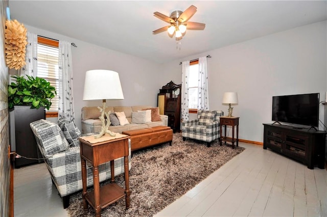 living room with ceiling fan, a wealth of natural light, and wood-type flooring