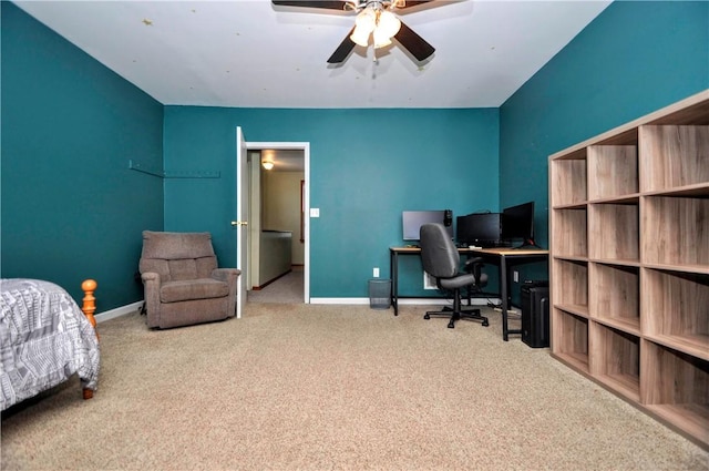 carpeted office space featuring ceiling fan