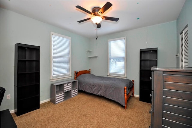 bedroom with ceiling fan and light colored carpet