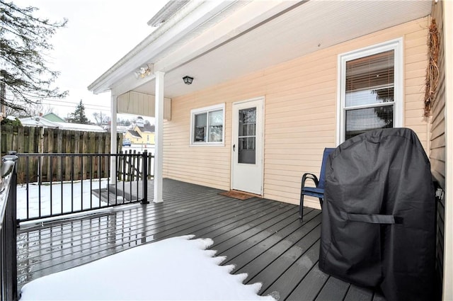 snow covered deck featuring a grill