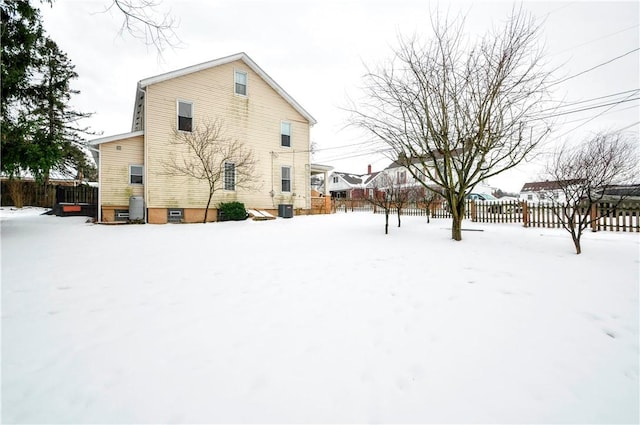 view of snow covered rear of property