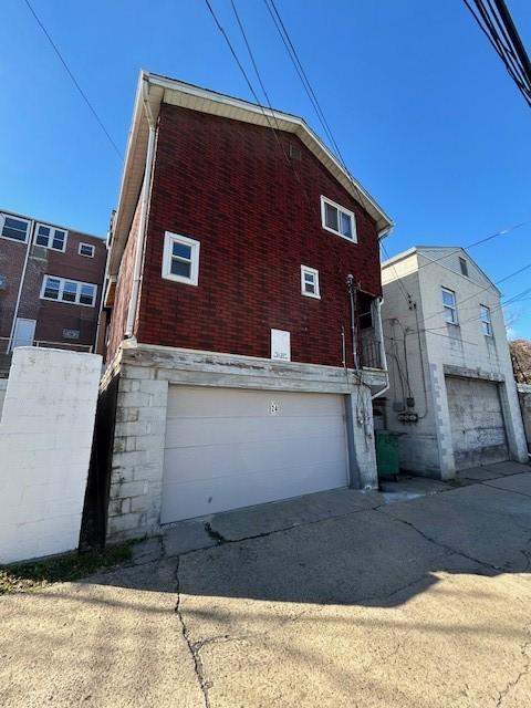 view of side of home with a garage