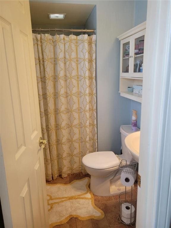 bathroom featuring tile patterned flooring and toilet