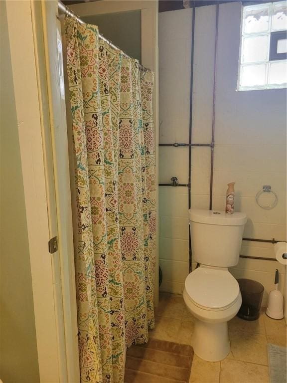 bathroom featuring tile patterned flooring and toilet