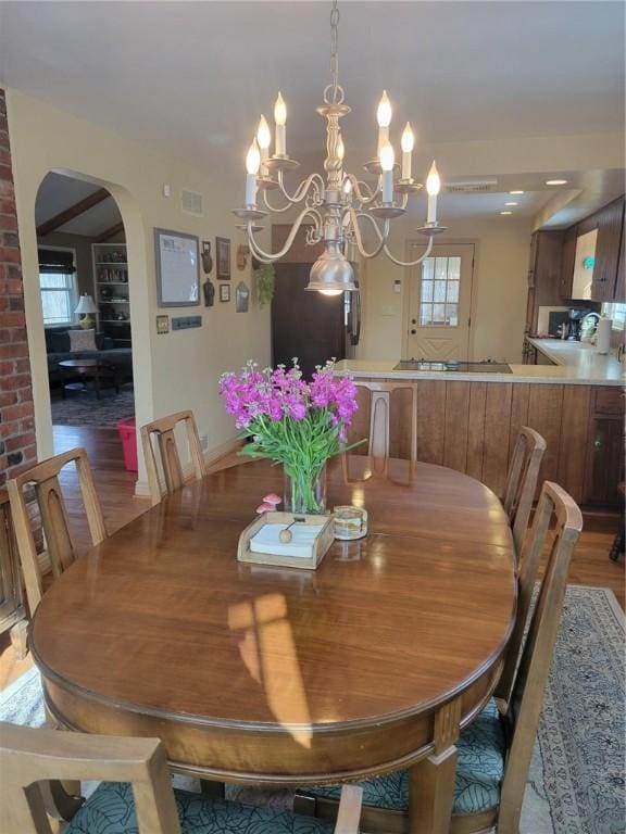 dining room with wood-type flooring and a chandelier