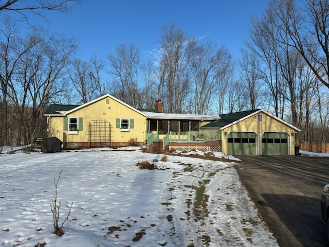 single story home with a porch and a garage