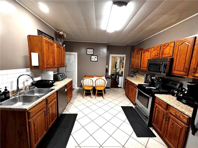 kitchen with stainless steel appliances, sink, and backsplash