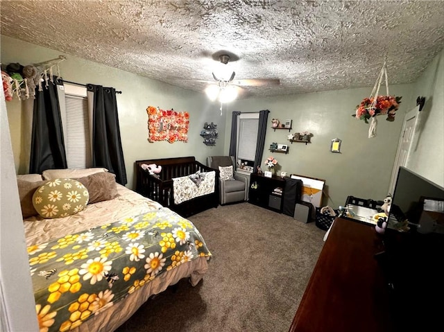 bedroom featuring ceiling fan, carpet, and a textured ceiling