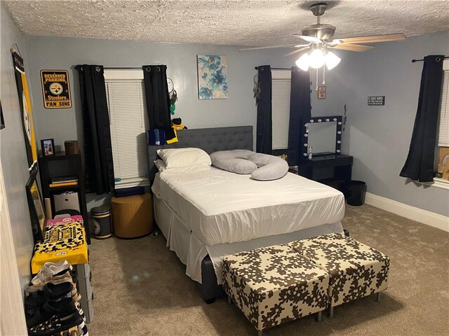 bedroom with a textured ceiling, ceiling fan, and carpet flooring