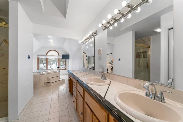 bathroom with tile patterned flooring, lofted ceiling, separate shower and tub, and vanity