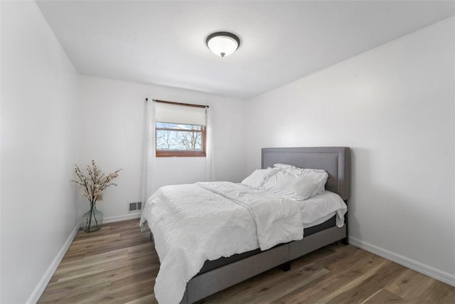 bedroom with hardwood / wood-style floors