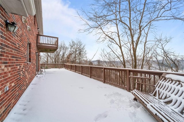 snowy yard featuring a deck