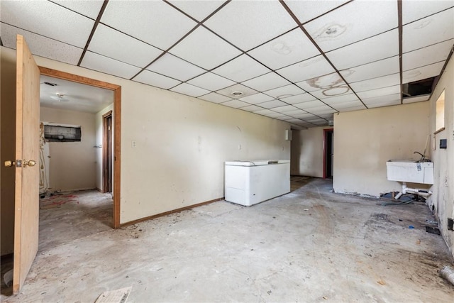 interior space featuring a drop ceiling and sink