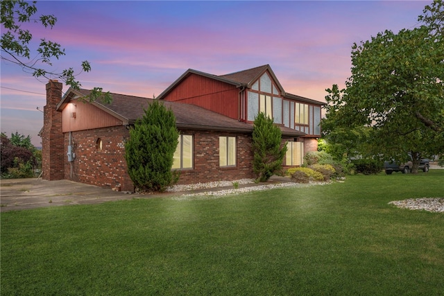 property exterior at dusk with a yard