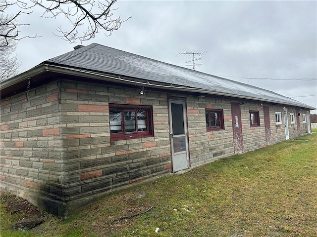 view of property exterior featuring a lawn