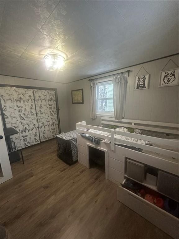 bedroom with dark wood-type flooring