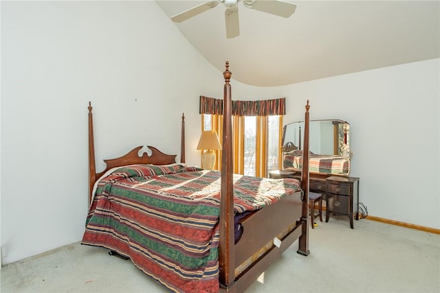 carpeted bedroom with ceiling fan and vaulted ceiling