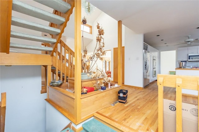 interior space featuring ceiling fan, wood-type flooring, and a wealth of natural light